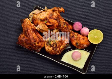 Top View of Tandoori Chicken with onion and lemon in Plate Stock Photo