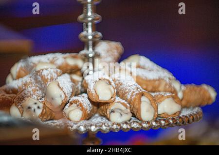 Cannoli siciliani pastry tray on dessert bar at traditional italian wedding Stock Photo