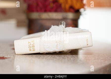 White white Holy Bible wrapped in lace on fall inspired table