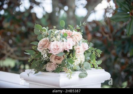 Pink roses and fresh eucaltpus bridal bouquet on white balcony Stock Photo