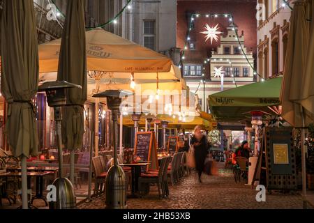 Leipzig, Germany. 15th Dec, 2021. Fairy lights hang over the Barfußgässchen in Leipzig's city centre. At Christmas time, the Transport and Public Works Department installs around 5,300 lamps in the streets and alleys of the city centre in addition to the public lighting. More than half of these are now energy-efficient LED lamps. Garlands of lights, Herrnhut stars and other Christmas motifs create a festive atmosphere. Along the Promenadenring there are around 174 fairy lights. Credit: Jan Woitas/dpa-Zentralbild/ZB/dpa/Alamy Live News Stock Photo