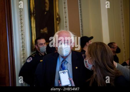 Washington DC, USA. 16th Dec, 2021. United States Senator Bernie Sanders (Independent of Vermont) talks with reporters as he arrives at the Senate chamber during a vote at the US Capitol in Washington, DC, USA, Thursday, December 16, 2021. Photo by Rod Lamkey/CNP/ABACAPRESS.COM Credit: Abaca Press/Alamy Live News Stock Photo