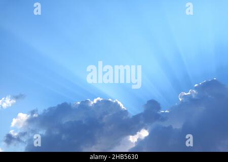 Spectacular Sun Rays Shining Through the Fluffy Clouds Stock Photo