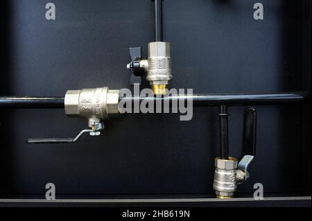 Ball valves placed on a stand. Plumbing equipment. Stock Photo