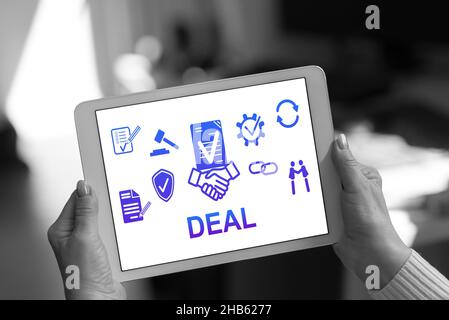 Deal concept shown on a tablet held by a woman Stock Photo