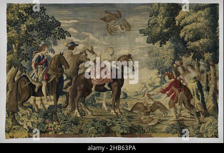 Falcon Hunt, The English Yachts (series title), Tapestry with Falcon Hunt: in the foreground four horsemen looking to the right. The front two horses, a blaze and a grey, are ridden by amazons; two dark horses by riders. In front of them is a heron on which a falcon stands with averted spread wings. A dog looks up at a heron in the air that is falling down under a shooting falcon. On the right are two men and a woman with flat. The scene is seen in a forest landscape with vistas in the center and tall trees on the sides, while the foreground is filled with large-flowered flowering plants Stock Photo