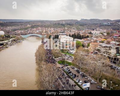 People walking in streets in Georgia capital. Aerial view Tbilisi tragedy anniversary demonstration. Stock Photo