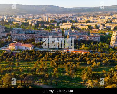 Mtskheta-Mtianeti district buildings with park in the foreground and mountains in the background. Soviet union style living property.3 2020