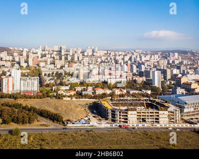 Olympc palace building with stadium construction site and Saburtalo district area real estate buildings in the background Stock Photo