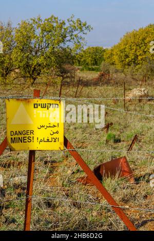 View of a trilingual warning sign - danger mines - in the Golan Heights. Northern Israel Stock Photo
