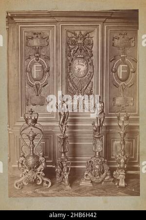 Arrangement of four wrought iron sculptures in front of a decorated wall, Fontainebleau (Château) (title on object), Séraphin-Médéric Mieusement (mentioned on object), Palais de Fontainebleau, c. 1875 - c. 1900, cardboard, albumen print, height 351 mm × width 247 mm