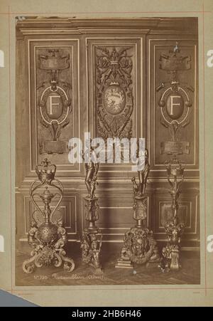 Arrangement of four wrought iron sculptures in front of a decorated wall, Fontainebleau (Château) (title on object), Séraphin-Médéric Mieusement (mentioned on object), Palais de Fontainebleau, c. 1875 - c. 1900, cardboard, albumen print, height 361 mm × width 250 mm