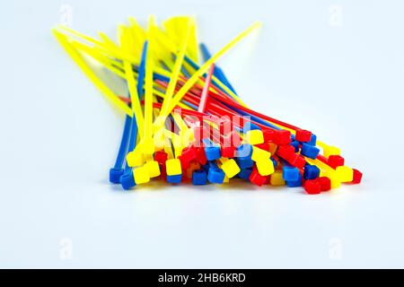Multicolored cable clamps on a white background in the center of the screen Stock Photo