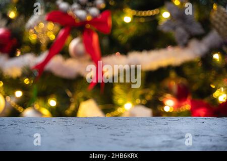 Christmas background with a table on the background of a decorated Christmas tree. Unfocused. Side view. Stock Photo