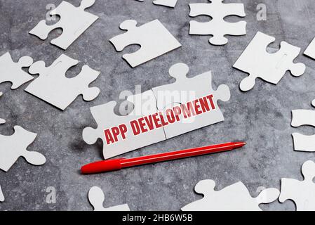 Handwriting text App Development. Word for Development services for awesome mobile and web experiences Building An Unfinished White Jigsaw Pattern Stock Photo