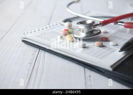 close up of pills and stethoscope on calendar , Stock Photo