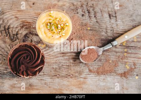 chocolate orange cake in a cup on a wooden background, top view. Stock Photo