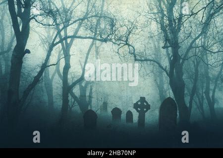 A horror concept of a spooky graveyard in a scary forest in winter, with the trees silhouetted by fog. With a muted, grunge edit. Stock Photo