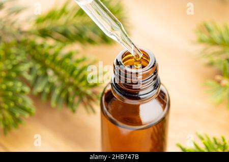 Fir essential oil in bottle still life. Herbal remedies Stock Photo