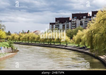 Ljubljana, Slovenia - 04 13 2018 View over the Ljubljana river with young people sitting at the banks Stock Photo