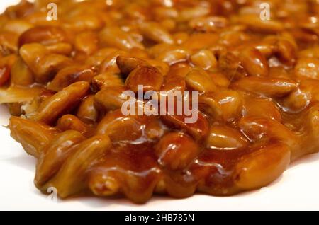 almonds caramelized prepare on restaurant kitchen isolate on white Stock Photo