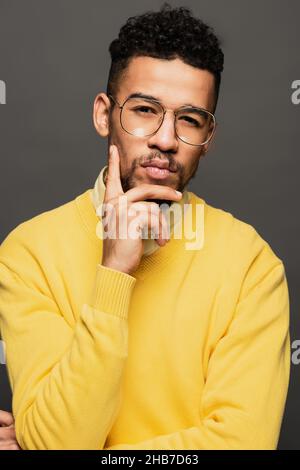 serious african american man in glasses looking at camera isolated on grey Stock Photo