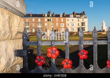 The war memorial at Redheugh Gardens,Hartlepool Headland on the north east coast of England,UK. Poppies on the railings Stock Photo