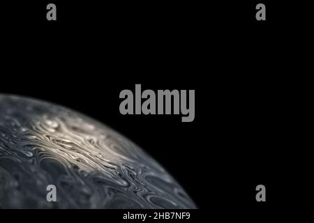 Grey colored cold alien planet, spotlighted by the sun with an atmosphere in universe on dark background. Soap bobble Stock Photo
