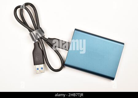 External Solid State drive with Cable Isolated on White Background Stock Photo