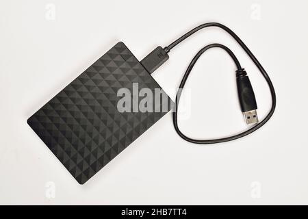 External Hard Disk with Cable on White Background Stock Photo