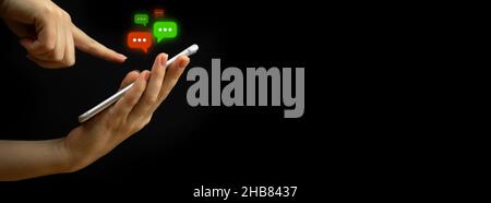 E-mail and social media. Banner, copy space. Woman hands using smartphone with new messages icon. Business and marketing concept, black background Stock Photo