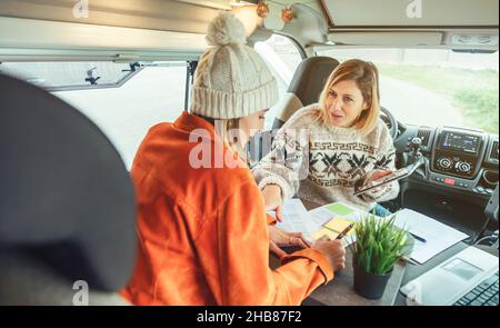 Women telecommuting in a camper van Stock Photo
