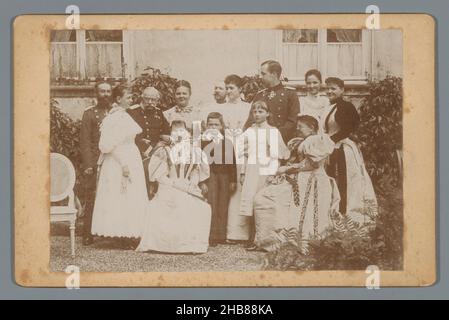 Group portrait of Queen Regent Emma's family, Queen Wilhelmina standing left, next to her George Victor van Waldeck-Pyrmont and Pauline van Waldeck-Pyrmont. Queen Regent Emma seated left with Helena van Waldeck-Pyrmont behind her on the right., anonymous, Germany, 1896 - 1897, cardboard, photographic support, height 107 mm × width 166 mm Stock Photo