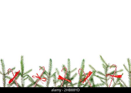 Christmas frame with fir branches and red decoration on white background. Flat lay, top view Stock Photo