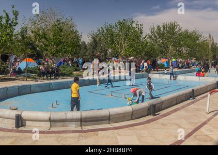 TEHRAN, IRAN - APRIL 2, 2018: People are camping and children playing in the park around Mausoleum of Ruhollah Khomeini near Tehran during the Nowruz Stock Photo