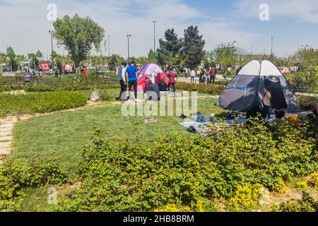TEHRAN, IRAN - APRIL 2, 2018: People are camping in the park around Mausoleum of Ruhollah Khomeini near Tehran during the Nowruz New Year celebrations Stock Photo