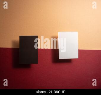 back and white mock up business cards on a yellow and red background . Stock Photo