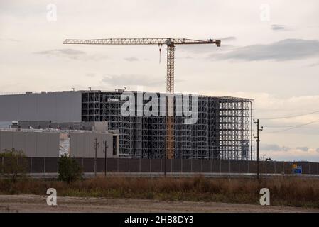 Warehouse under construction without external wall. Metal shelves of a future logistics center. Stock Photo