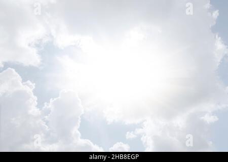 Sun shining through white clouds Stock Photo