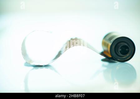 Studio shot of spool of 35mm film with some film pulled out Stock Photo ...