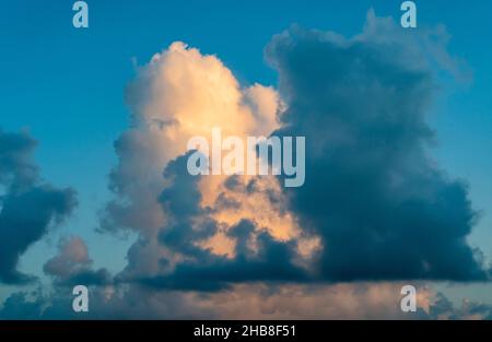 Large golden cumulus cloud against sky Stock Photo