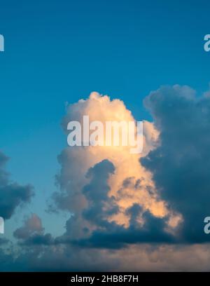 Large golden cumulus cloud against sky Stock Photo