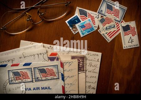 Letters with American flag postage stamps on table Stock Photo