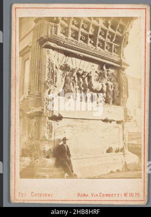 Relief in the Arch of Titus, Rome: Titus as triomfator, Arc de Triomphe de Titus (title on object), Tomasso Cuccioni (mentioned on object), anonymous, Rome, 1855 - 1885, cardboard, paper, albumen print, height 100 mm × width 69 mm Stock Photo