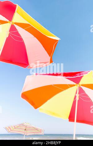 Beach umbrellas against blue sky Stock Photo