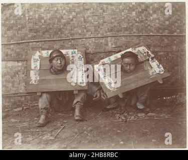 Two Chinese prisoners with their heads in wooden boards, Raimund von Stillfried-Ratenitz (possibly), Felice Beato (possibly), 1860 - 1885, photographic support, cardboard, albumen print, height 310 mm × width 405 mm Stock Photo