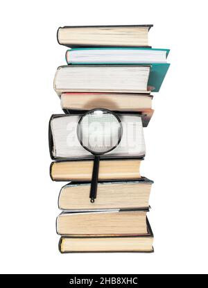 Magnifying lens over books stack isolated on white background. Concept of knowledge and studying. Stock Photo