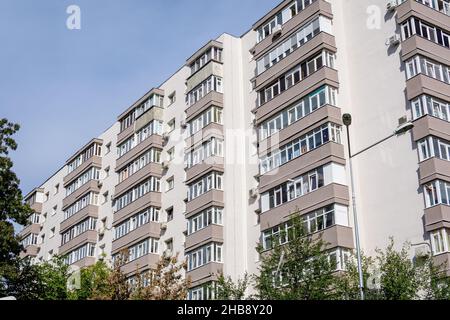 Renovated typical old block of flats towards clear blue sky in Bucharest, Romania Stock Photo