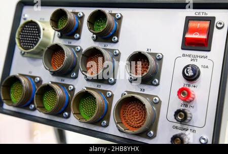 Modern electronic device for relay protection testing and commissioning closeup. Power cable connections. Stock Photo