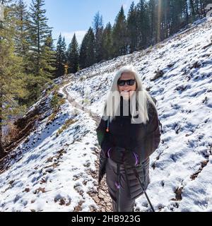 USA, Idaho, Ketchum, Woman hiking on snowy trail near Sun Valley Stock Photo